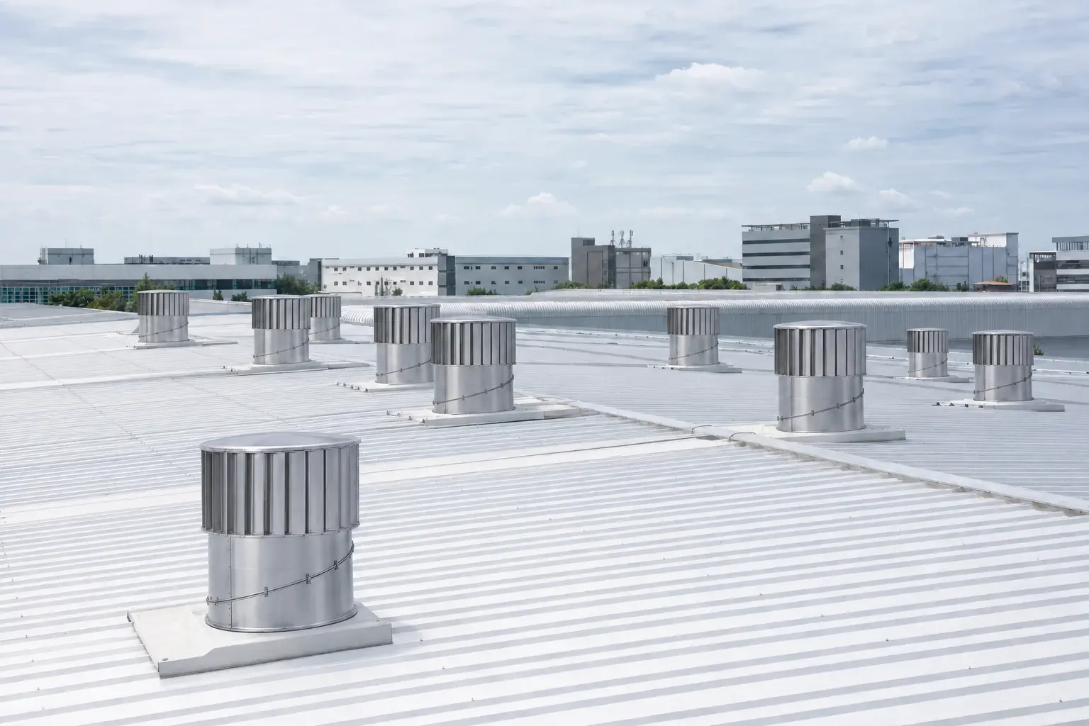 Industrial roof with wind-driven ventilators.
